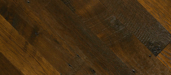 A close-up of "Old Rafter" showcases a diagonal layout of dark brown planks with textured surfaces and visible grain. Its rustic, natural look is enhanced by small knots and imperfections that add to its character.