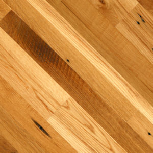 Close-up of the Antique Oak wooden floor with varying brown tones and distinct wood grain patterns. The diagonally laid planks feature dark knots and natural imperfections, enhancing its rustic appearance.