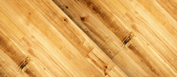 Rustic Hickory features wooden floor panels with natural grain patterns and knots arranged diagonally, highlighted by a warm honey-toned finish for added texture and depth.