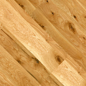 Close-up of Traditional White Oak flooring with a traditional finish, showcasing detailed grain patterns and knots. The planks are arranged diagonally, highlighting the texture and warm, earthy tones.