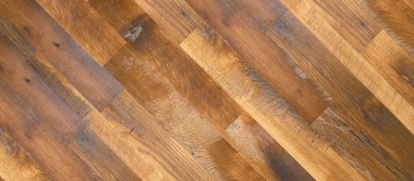 Close-up of Rustic Oak wooden floor, crafted from reclaimed oak with natural grain texture, warm brown hues, and subtle color variations. Planks are arranged diagonally, creating a dynamic and rustic pattern.