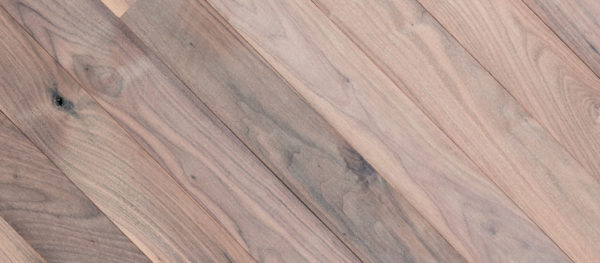 Close-up of Sea Shell wood surface with diagonal planks, showcasing a natural finish with varied tones and grain. Light browns and grays form a subtle, rustic pattern.