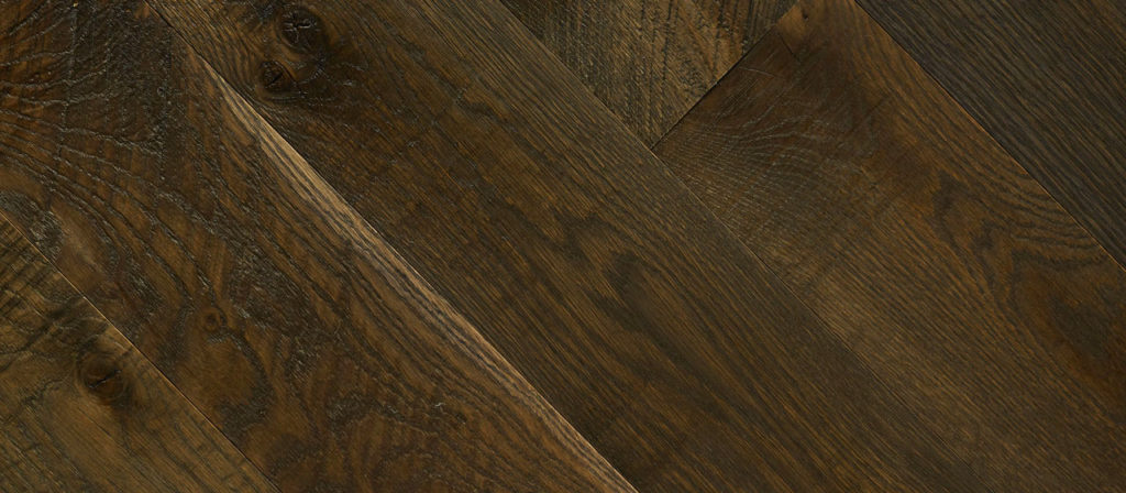 The Summer Cabin flooring features a diagonal plank pattern in dark wood, evoking the warmth and invitation of a summer cabin. Its richly textured wood grain highlights natural elegance.