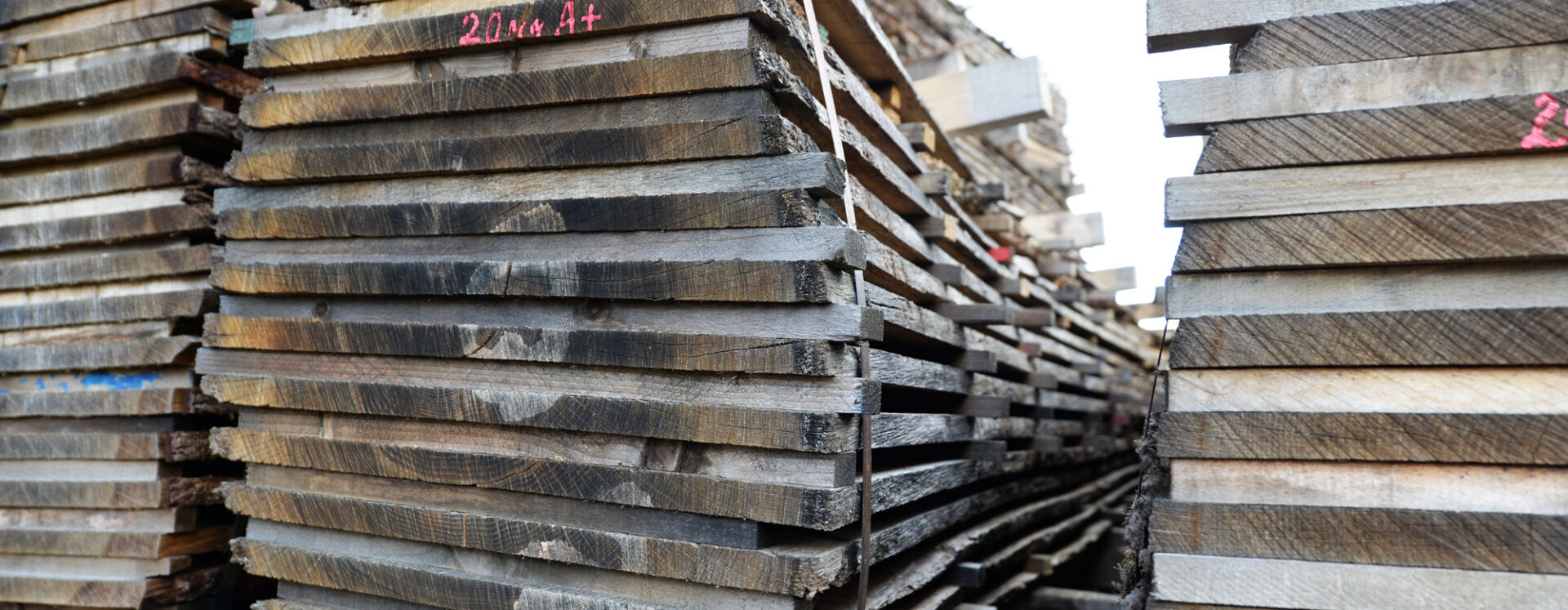 Several piles of cut wooden planks that can be used to create wide plank wood flooring