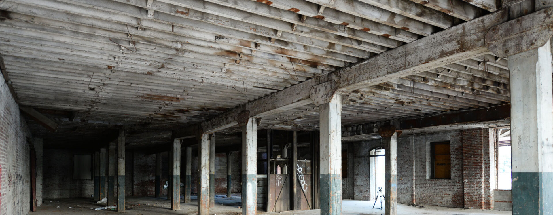 An old industrial building with wooden joists and ceilings that can be repurposed for wide plank wood flooring