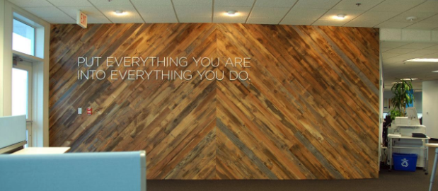 Feature wall in office building made from wood panels installed at an angle.