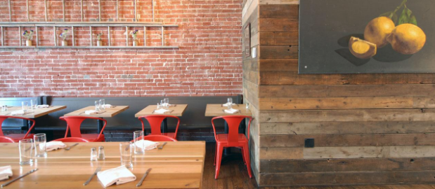 Barn wood paneling wraps around a corner in a restaurant.