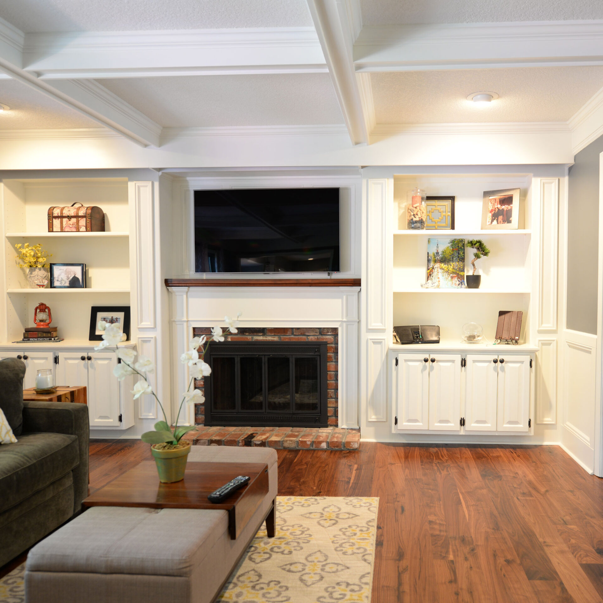 A well-decorated living room featuring beautiful wide plank wood flooring