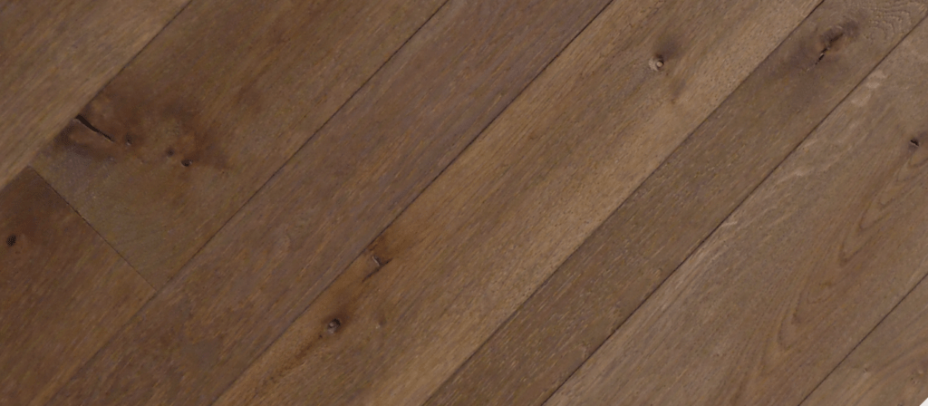 A close-up of the Twilight River wooden surface showcases diagonal planks in medium brown, resembling a river at dusk. The visible grain patterns and natural knots enhance its rustic charm, echoing nature's tranquility.