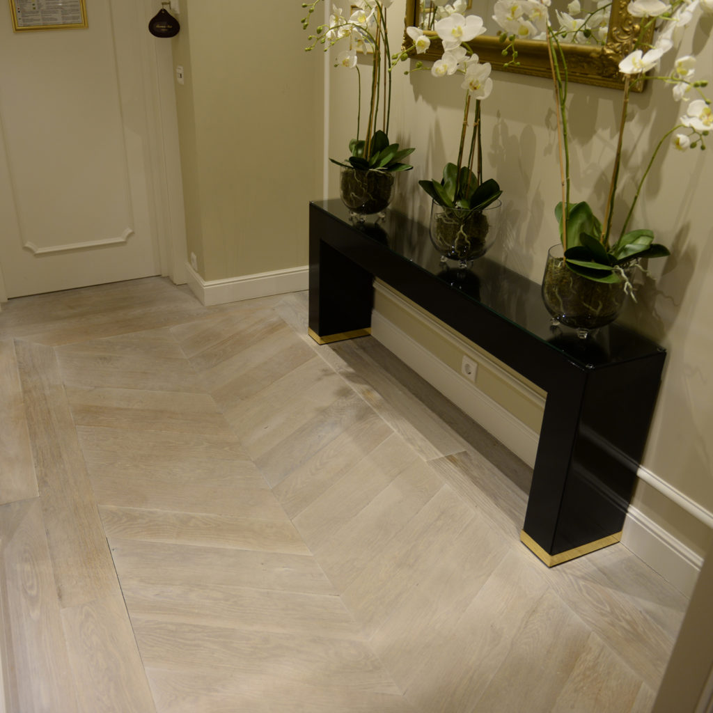 Whitewashed wood flooring in a chevron layout