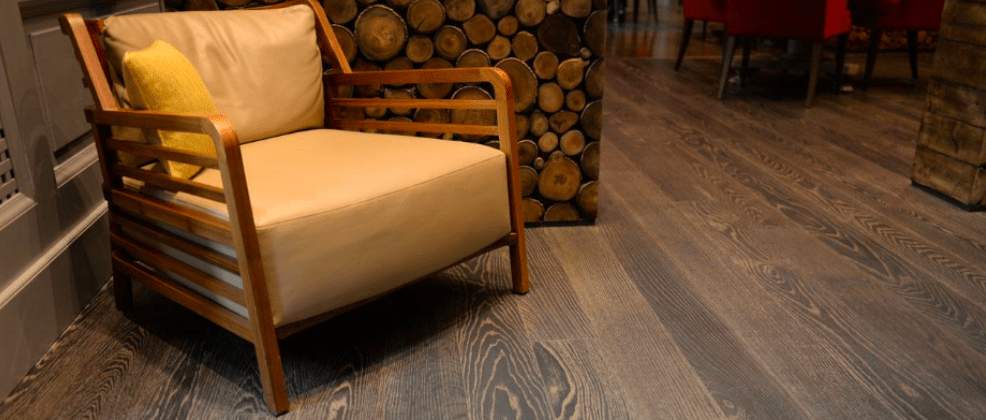 Accent chair on rustic textured wood flooring