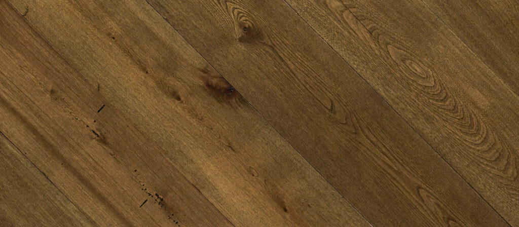 A close-up of dark wide plank floors laid diagonally reveals wood in a rich brown color, with visible grain patterns and knots. The texture showcases natural imperfections and variations, enhancing its rustic appearance.