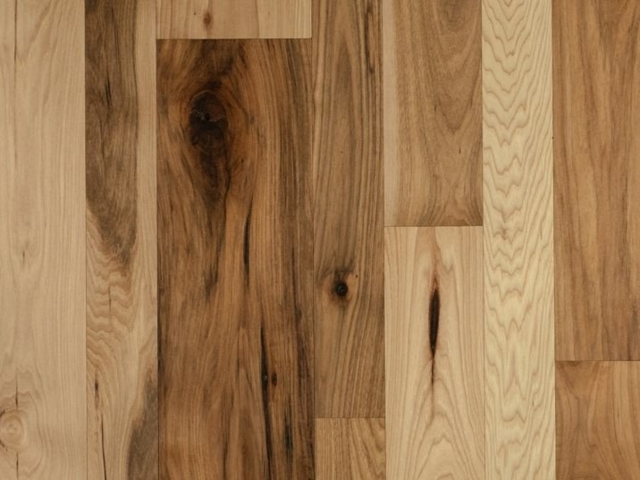 Close-up of wooden floorboards with a mix of light and dark brown shades, showcasing natural wood grain patterns and textures—perfect for those seeking specials in our inventory.