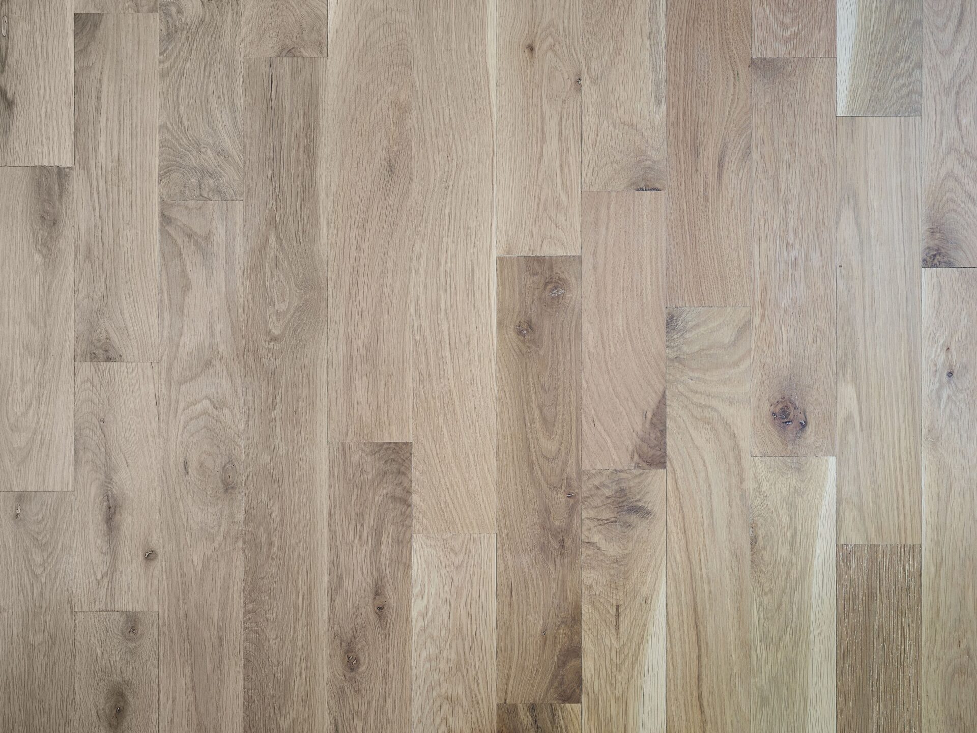 Unfinished white oak hardwood for sale with natural grain and varying plank shades.