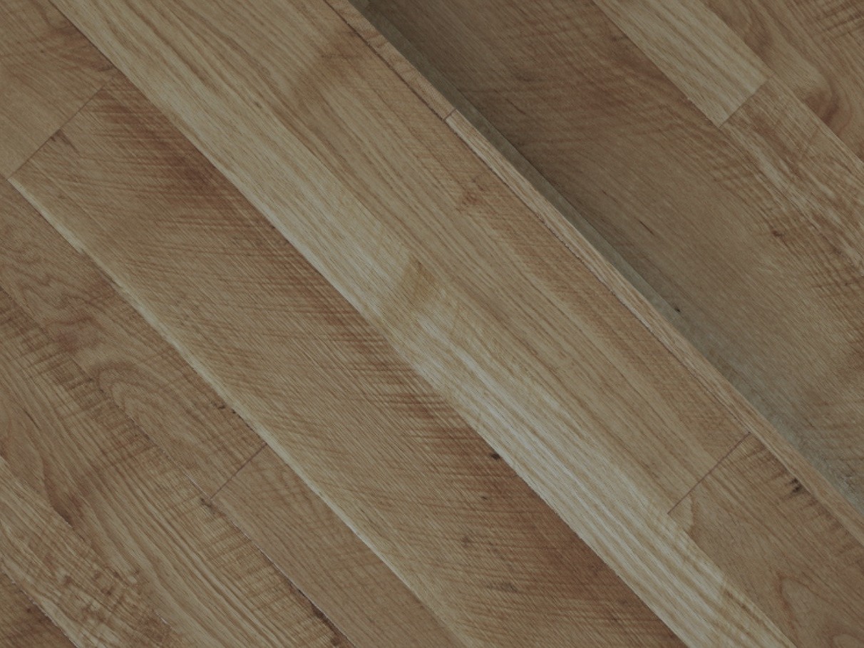 Close-up of light brown milled hardwood for sale, arranged diagonally with visible wood grain patterns.